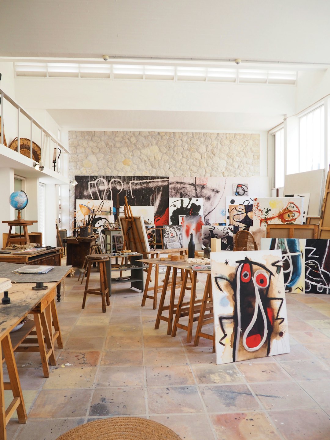 Künstleratelier voller abstrakter Gemälde und Kunstbedarf.